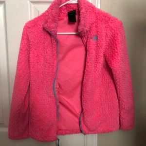 A bright pink with blue accent north face zip up